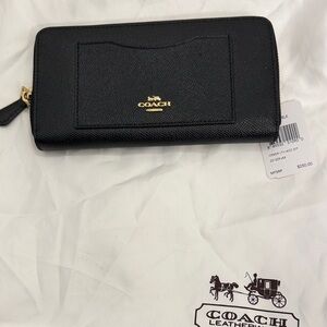 Black Leather Coach Wallet with gold trim.